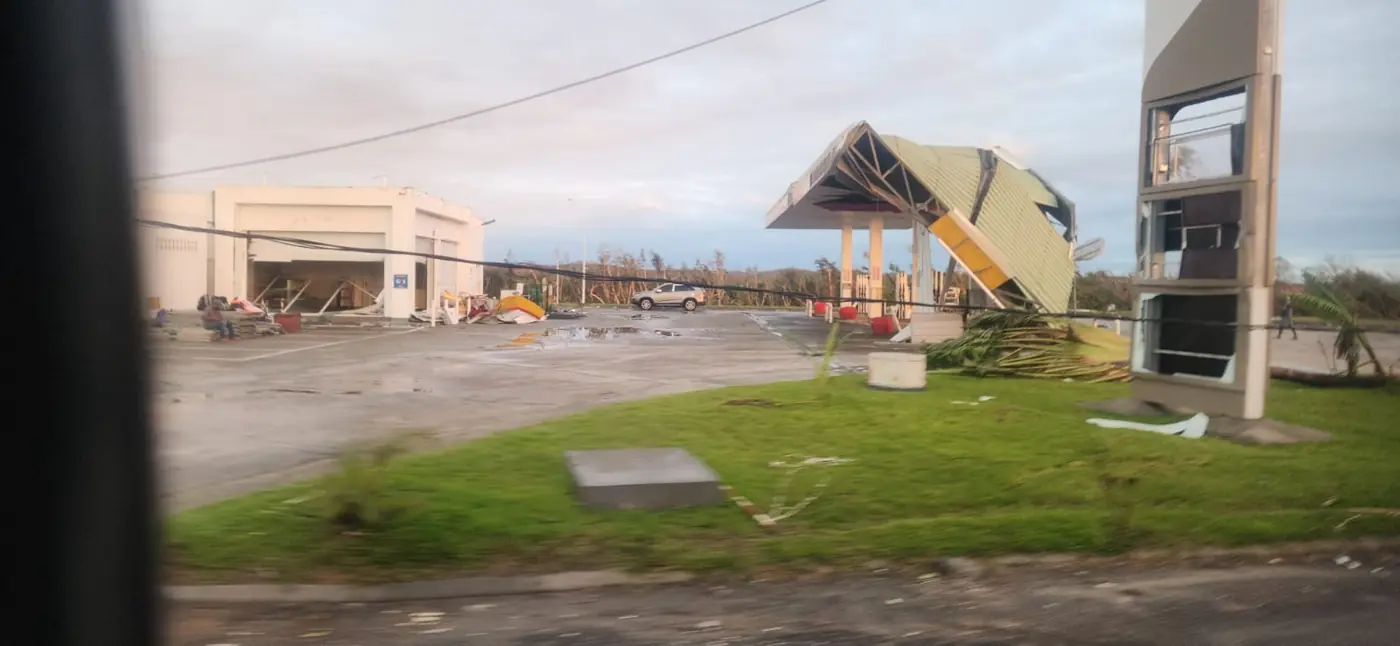 A service station in Toamasina has a bent and partly collapsed canopy, broken windows and debris scattered across its forecourt.