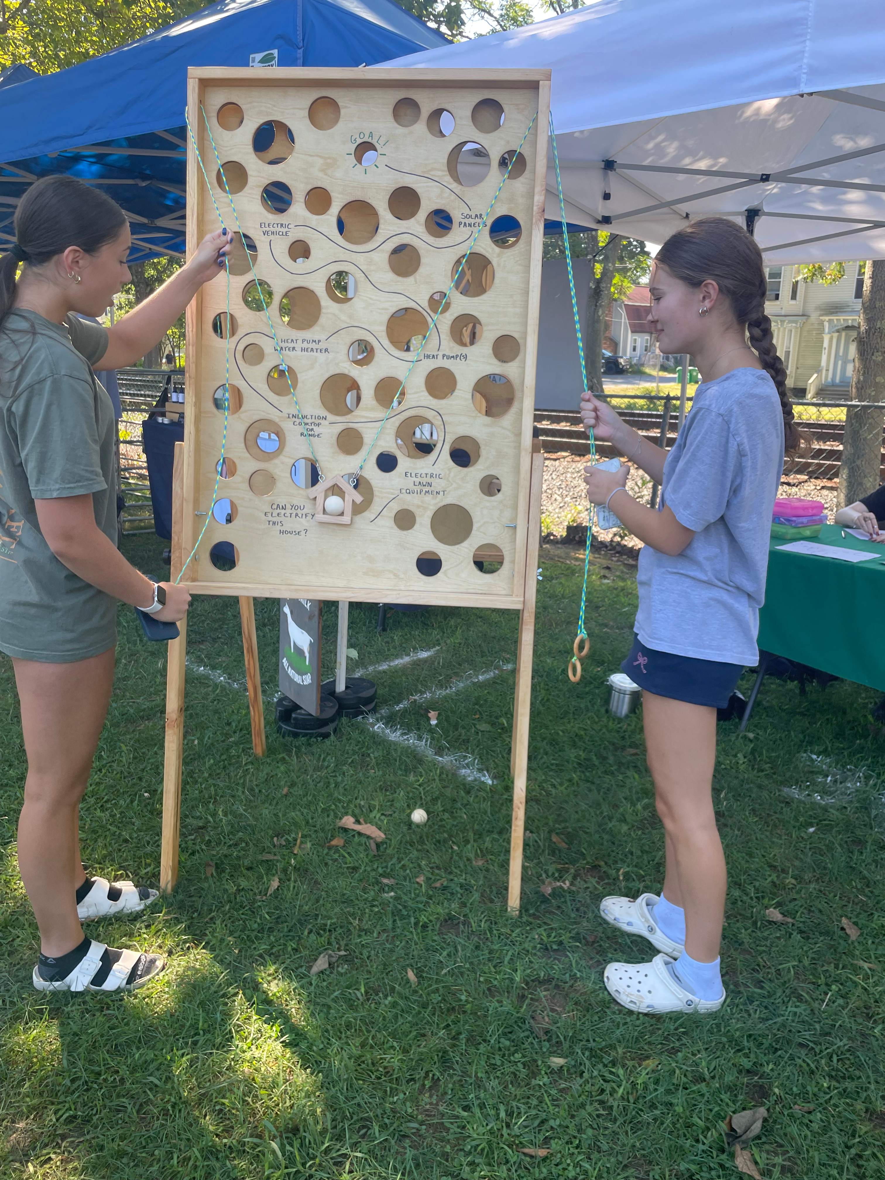 Interactive electrification game board at community event